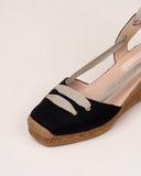 Black linen espadrilles. Closed at the toe, with natural ribbon detail on top. Tie-up knotted at the ankle. Square toe medium jute wedge.  100% natural leather insole.