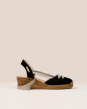 Black linen espadrilles. Closed at the toe, with natural ribbon detail on top. Tie-up knotted at the ankle. Square toe medium jute wedge.  100% natural leather insole.